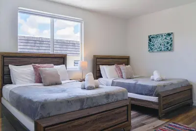 a bedroom with two beds and a large window at Awesome 3BR Townhouse 15minutes from the Beach in Miami