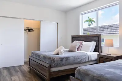 a bedroom with two beds and a large window at Awesome 3BR Townhouse 15minutes from the Beach in Miami