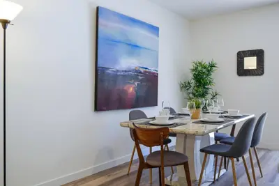 a dining room table with chairs and a painting on the wall at Awesome 3BR Townhouse 15minutes from the Beach in Miami