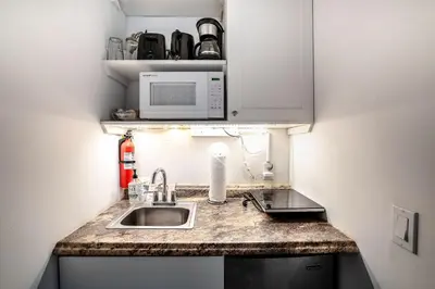 a small kitchen with a sink and a microwave at B efficiency Off Las Olas on water free kayaks in Fort Lauderdale