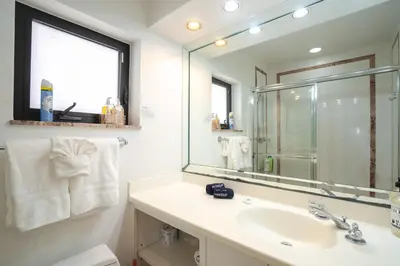 a bathroom with a sink and a mirror at B efficiency Off Las Olas on water free kayaks in Fort Lauderdale