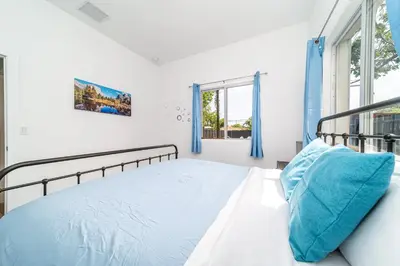a bedroom with a bed and a window at Pool Boutique Villa by the Beach 1 in Hallandale Beach