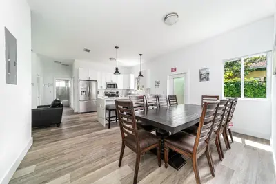 a kitchen and dining room with a table and chairs at Pool Boutique Villa by the Beach 1 in Hallandale Beach