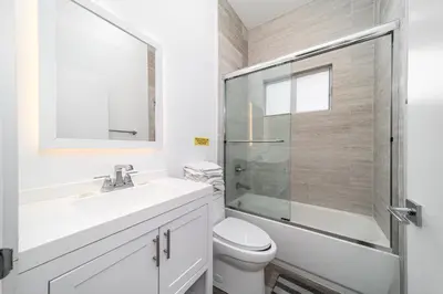 a bathroom with a toilet and a sink and a shower at Pool Boutique Villa by the Beach 1 in Hallandale Beach