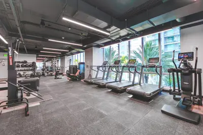 a gym with treadmills and machines in a room at Stylish Stay in the Heart of Miami - Walk to Bayside & Bayfront Park in Miami