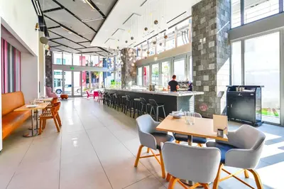 a restaurant with tables and chairs and a bar at Stylish Stay in the Heart of Miami - Walk to Bayside & Bayfront Park in Miami