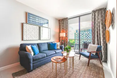 a living room with a couch and a table at Modern Hotel with Pool & Gym in Prime Doral Location in Miami