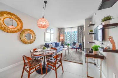 a living room with a table and a couch at Modern Hotel with Pool & Gym in Prime Doral Location in Miami