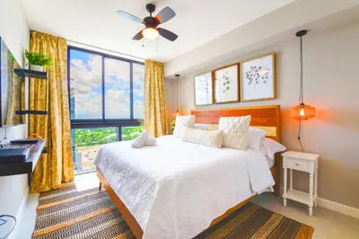 a bedroom with a bed and a large window at Modern Hotel with Pool & Gym in Prime Doral Location in Miami