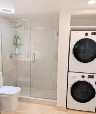 a washing machine in a bathroom with a shower at Condo in Brickell Business District in Miami
