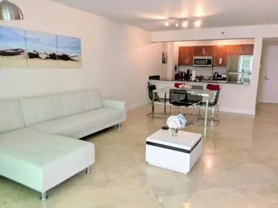 a living room with a white couch and a table at Condo in Brickell Business District in Miami
