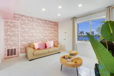 a living room with a couch and a table at Free Parking, Bay View, Pool, Step To Beach in Hollywood