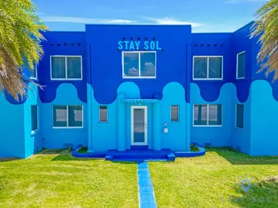 a blue building with a sign that reads stay evil at Free Parking, Bay View, Pool, Step To Beach in Hollywood