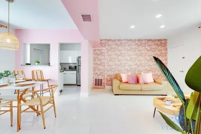 a living room with a yellow couch and a table at Free Parking, Bay View, Pool, Step To Beach in Hollywood
