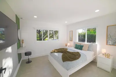a white bedroom with a bed and two windows at Heated pool in a Precious House close to Zoo Parks and Arts in Cutler Bay