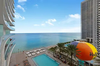 a view of a pool and the ocean from a building at Beachfront Condo - Amazing Pool - Oceanview Balcony in Hollywood