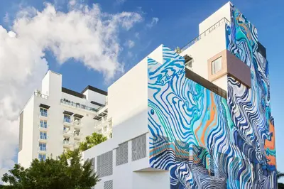 a building with a painting on the side of it at Arlo Wynwood Miami in Miami