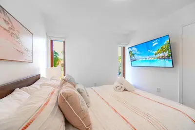 a woman laying on top of a bed in a bedroom at Family-Friendly 4BR House with Pool in Westchester Miami in Tamiami