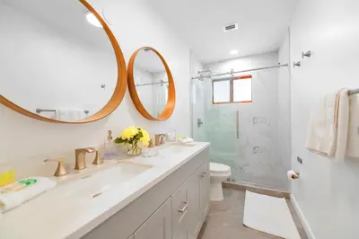 a bathroom with a sink and a mirror at Family-Friendly 4BR House with Pool in Westchester Miami in Tamiami
