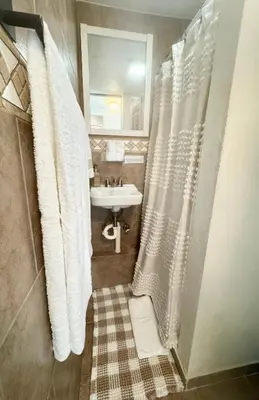 a bathroom with a white shower curtain and a sink at Boutique Private Guest Suite with Private Entrance & Self Check In Near Hard Rock Cruise Port & FLL Airport in Fort Lauderdale