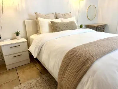 a bedroom with a white bed and a night stand at Boutique Private Guest Suite with Private Entrance & Self Check In Near Hard Rock Cruise Port & FLL Airport in Fort Lauderdale