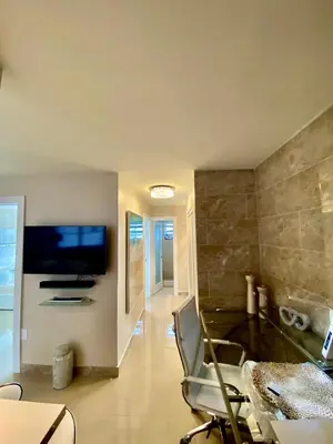 a living room with a chair and a flat screen tv at Premium Modern waterfront apartment with Miami Skyline view on the bay 5 mins drive to Miami Beach with free parking in Miami Beach