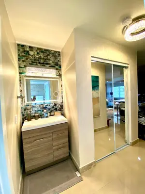 a bathroom with a sink and a mirror at Premium Modern waterfront apartment with Miami Skyline view on the bay 5 mins drive to Miami Beach with free parking in Miami Beach