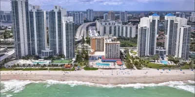 an aerial view of a beach in front of a city at Ramada Marco Polo Beach in Miami Beach