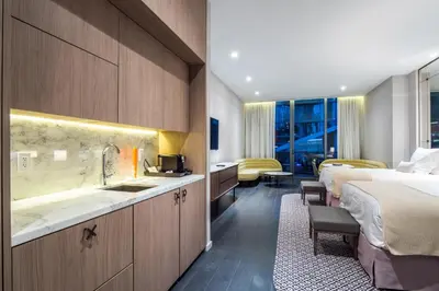 a hotel room with two beds and a sink at Suites at SLS Lux Brickell managed by CE in Miami