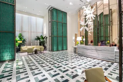 a lobby of a hotel with green and white tiles at Suites at SLS Lux Brickell managed by CE in Miami