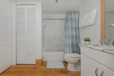 a bathroom with a toilet and a tub and a sink at Lovely condo with city & ocean views. Sleep up to 6 people! in Miami