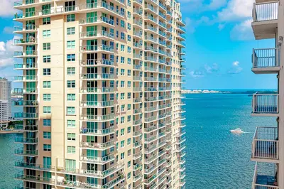 a tall building next to the water with acean at Lovely condo with city & ocean views. Sleep up to 6 people! in Miami