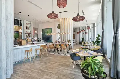 a restaurant with tables and chairs and a bar at Ocean View Beachfront 2Bed/2B M-Penthouse @HYDE in Hollywood