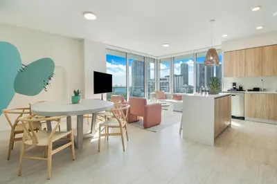 a kitchen and living room with a table and chairs at Nomada Destination Residences - Quadro in Miami