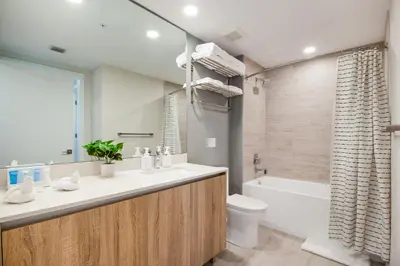 a bathroom with a sink and a toilet and a tub at Nomada Destination Residences - Quadro in Miami