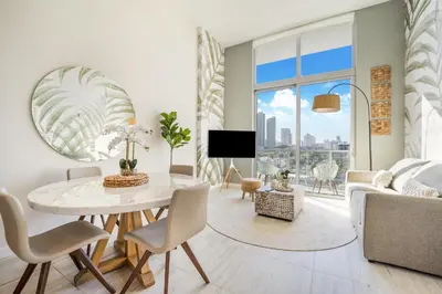 a living room with a table and a couch at Nomada Destination Residences - Quadro in Miami