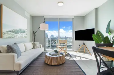 a living room with a couch and a tv at Nomada Destination Residences - Quadro in Miami