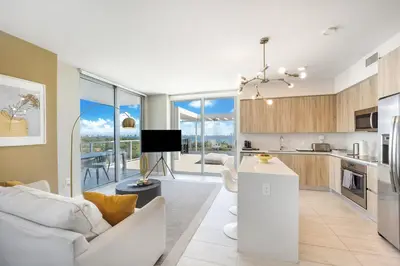 a kitchen and living room with a couch and a table at Nomada Destination Residences - Quadro in Miami