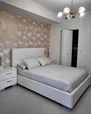 a bedroom with a large white bed and a dresser at DOWNTOWN DORAL, FLORIDA. NEW CONDO STYLE RESORT. in Miami