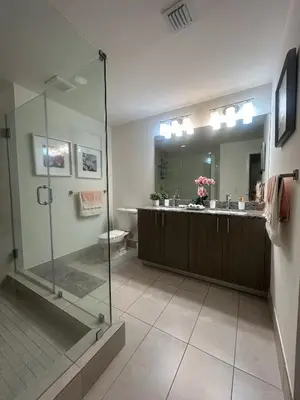 a bathroom with a glass shower and a toilet at DOWNTOWN DORAL, FLORIDA. NEW CONDO STYLE RESORT. in Miami