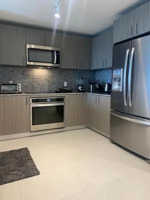 a kitchen with a stainless steel refrigerator and microwave at DOWNTOWN DORAL, FLORIDA. NEW CONDO STYLE RESORT. in Miami