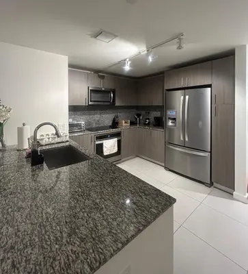 a kitchen with granite counter tops and a stainless steel refrigerator at DOWNTOWN DORAL, FLORIDA. NEW CONDO STYLE RESORT. in Miami