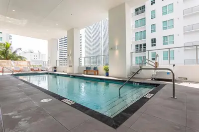 a swimming pool in a building with tall buildings at Amazing Condo in Downtown Miami/Brickell w/PARKING in Miami