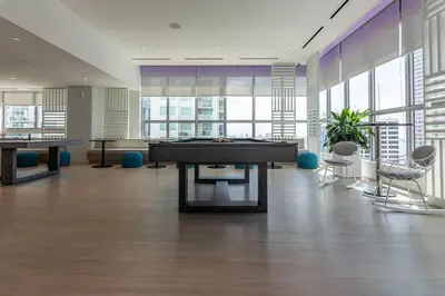 a large room with a pool table and chairs at Amazing Condo in Downtown Miami/Brickell w/PARKING in Miami