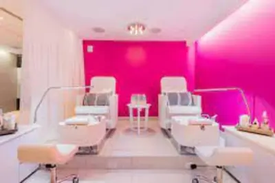 a salon with pink walls and white chairs and sinks at 1 Bedroom with ocean and city views! in Fort Lauderdale