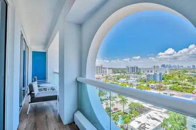 a room with a balcony with a view of a city at Studio Suite at Fort Lauderdale in Fort Lauderdale