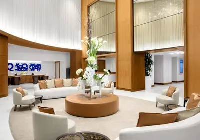 a lobby with couches and a table with flowers at Studio Suite at Fort Lauderdale in Fort Lauderdale