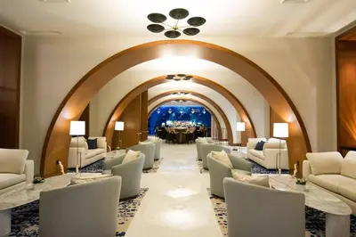 a waiting room with white chairs and a table at Studio Suite at Fort Lauderdale in Fort Lauderdale