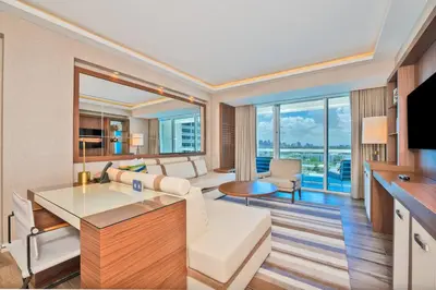 a living room with a white couch and a living room with a view at Studio Suite at Fort Lauderdale in Fort Lauderdale