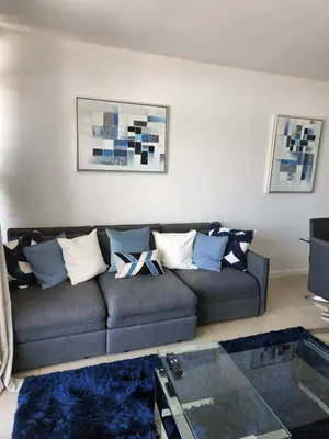 a living room with a couch and a glass table at Wonderful 1 bedroom condo in Midtown. in Miami
